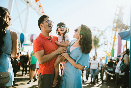 Family Has Fun at Outdoor Carnival Setting stock photo