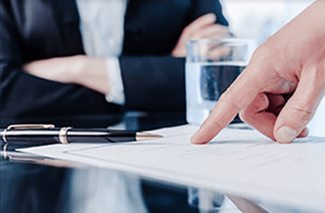 Hand pointing at a document