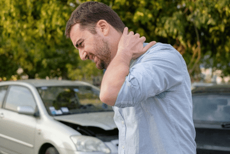 Man grabbing his neck after a car accident